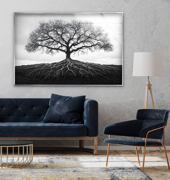 High-contrast black and white glass wall art of a majestic tree with detailed roots symbolizing growth.
