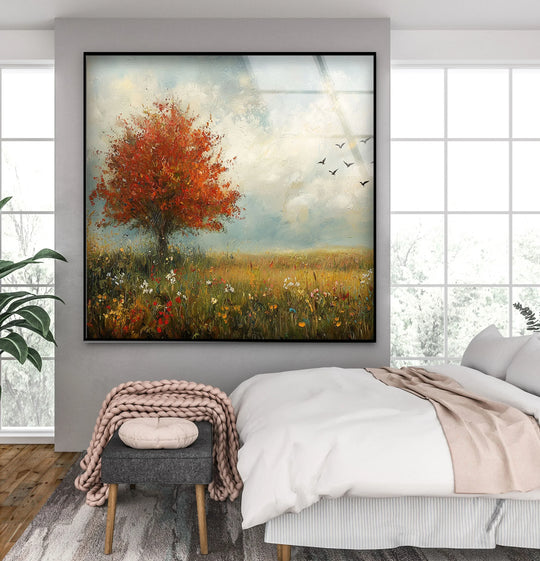 Surrounding a square art from glass print of a blooming tree in a field, bright negative space enhances the painting’s serene, natural landscape.