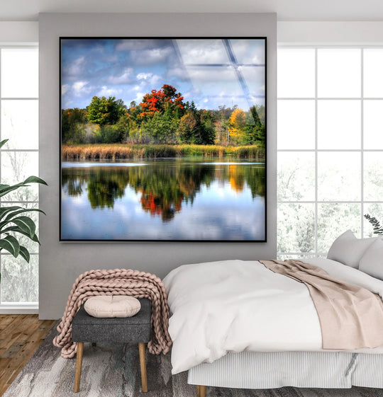 Showcasing the layering effect, this autumn reflections scenic forest lake glass wall art decor presents a mesmerizing depth created by the lakeside trees and reflected sky.