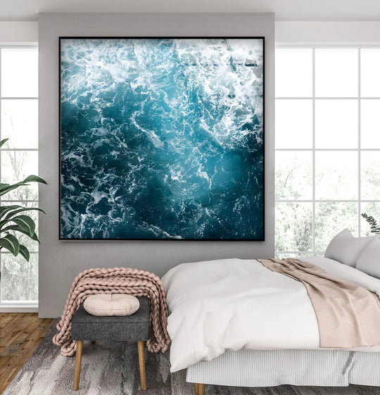 Vibrant azure and deep teal ocean hues create striking color contrast in this glass wall art decor.