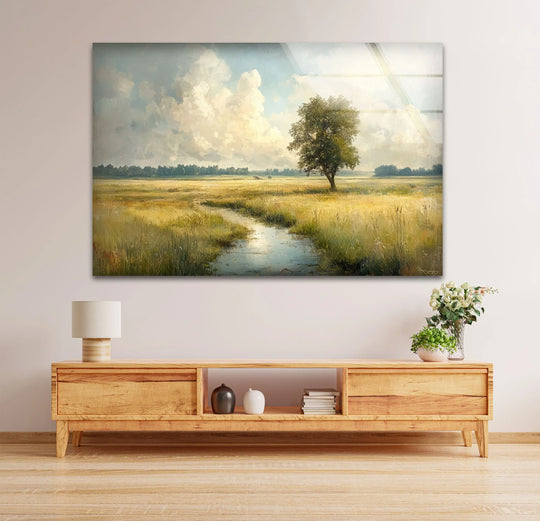 Stillness pervades the golden meadow glass printing art, featuring a lone tree beside a tranquil stream, evoking a peaceful countryside panorama.