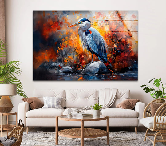 A great blue heron stands tall in the brightest area of fiery autumn foliage within this stunning glass art painting.