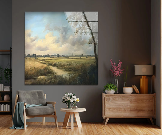 Sunlit clouds illuminate the horizon in this landscape glass wall artwork, highlighting the golden meadow and stream in a serene countryside vista.