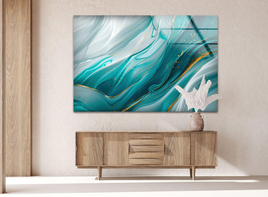 Negative space surrounds abstract blue and gold waves in this beautiful glass wall art.