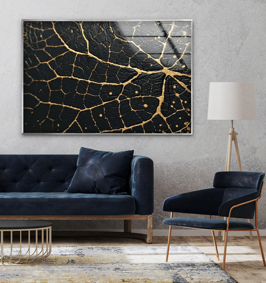 Intricate gold veins highlight the textured black surface of this stunning piece of abstract glass art.