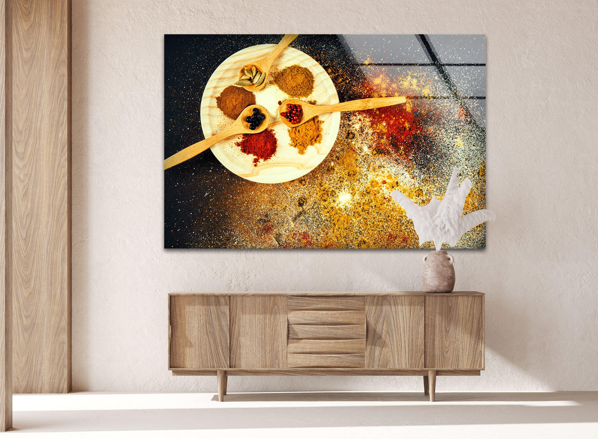 Showcasing the abstract quality of yellow spice hanging wall art, the glass piece captures the swirling essence of colorful spices on a black background.
