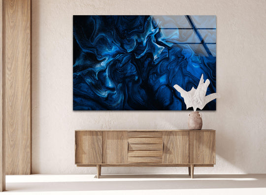 Dominating the wall, the vivid dark blue abstract glass hanging wall art features swirling patterns and shimmering light.