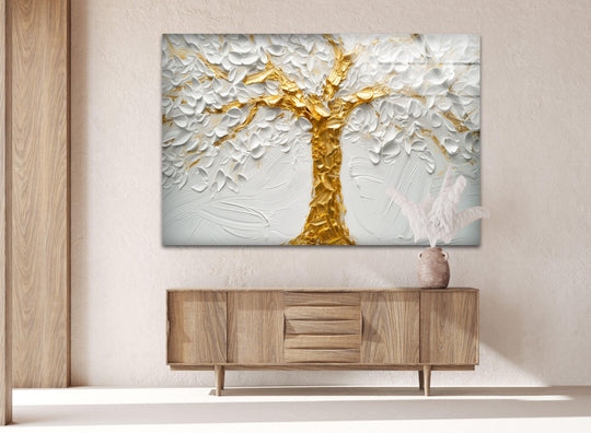 The textured brushstrokes and shimmering gold accents of the golden tree with white flower wall prints give the abstract glass wall art a feeling of dynamic movement.