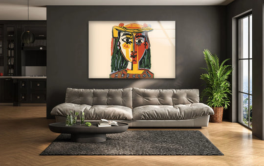 A captivating Picasso Woman with a Hat glass wall art decor, featuring drinks and a book on a coffee table.