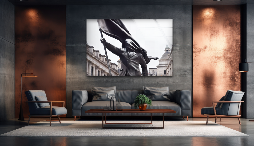 The darkest area, featuring deep charcoal concrete walls and minimalist dark furniture, frames the iconic Banksy Flag Bearer glass art.