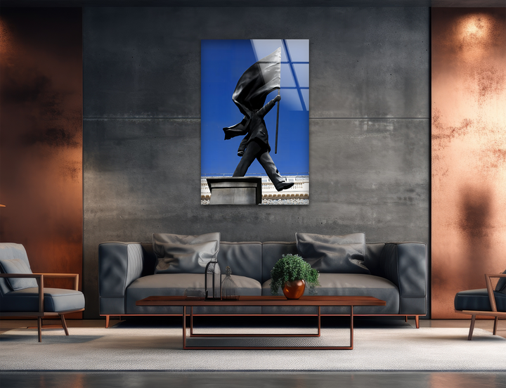 The focal point is striking Banksy glass wall art showing a dark flag-bearing statue against a vibrant blue sky, a powerful home decoration.