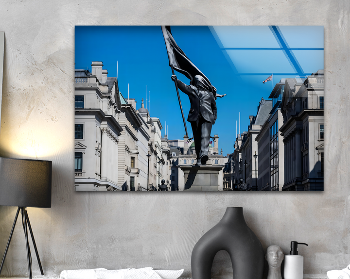The stark contrast of light and shadow highlights the dynamic Freedom March Statue with a flag against a brilliant blue sky, presented as best glass art.