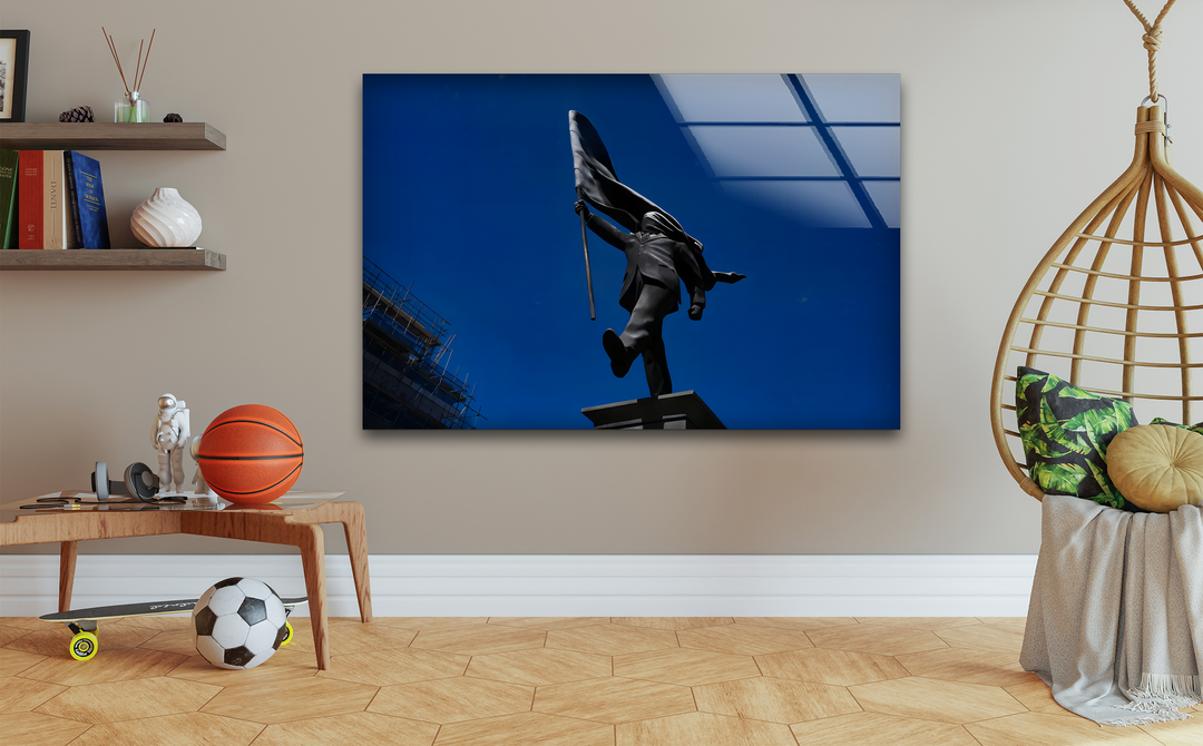 The striking color contrast in this print wall art highlights the dark, silhouetted statue against a vibrant blue sky, creating a bold visual.