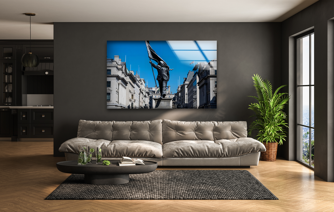A plush beige sofa, the room's softest element, grounds the space beneath a captivating Freedom March Statue best glass art piece.