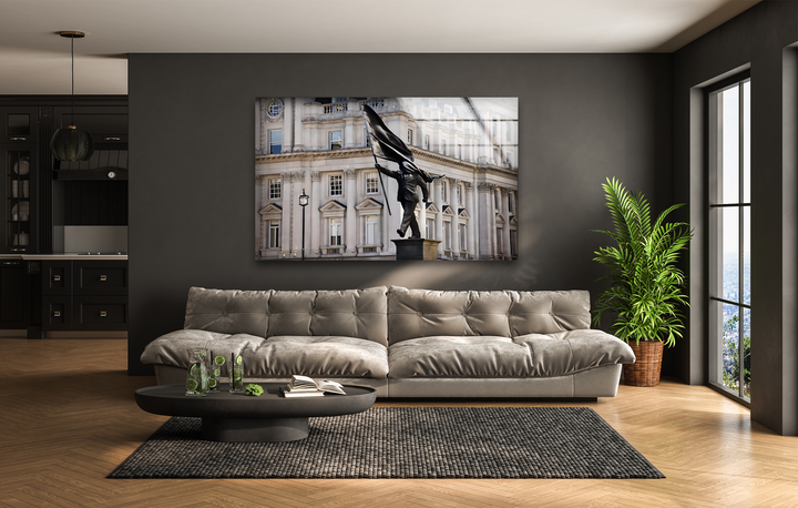The glossy finish of this Banksy London glass wall art decor reflects light, enhancing the striking Stride of Freedom Statue.