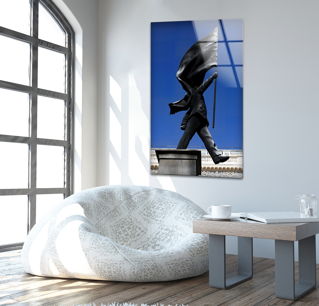 Depth and layers are evident in this Banksy Flag Statue glass hanging wall art, with the walking figure and flowing flag against a vibrant blue sky.