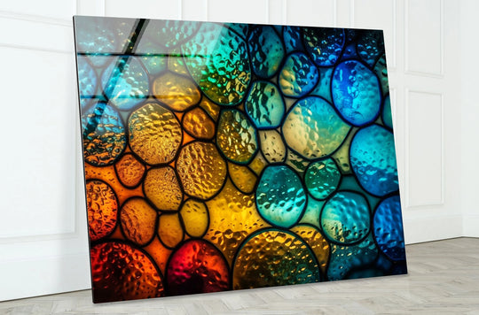 Abstract glass home decor showcasing a vibrant color transition from deep reds and oranges to bright yellows, turquoise, and blues.