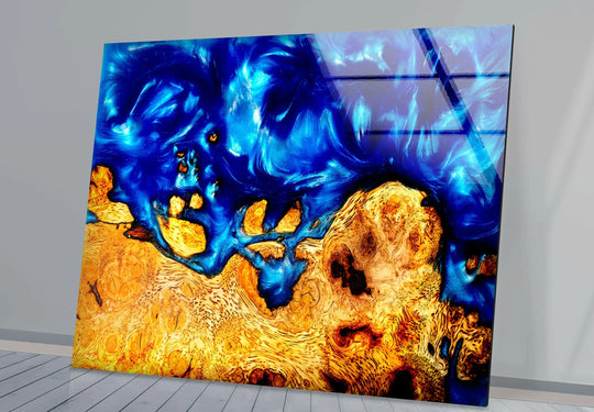 Abstract epoxy resin and wood glass wall art prints feature swirling sapphire blue resin art and rich golden wood grain.