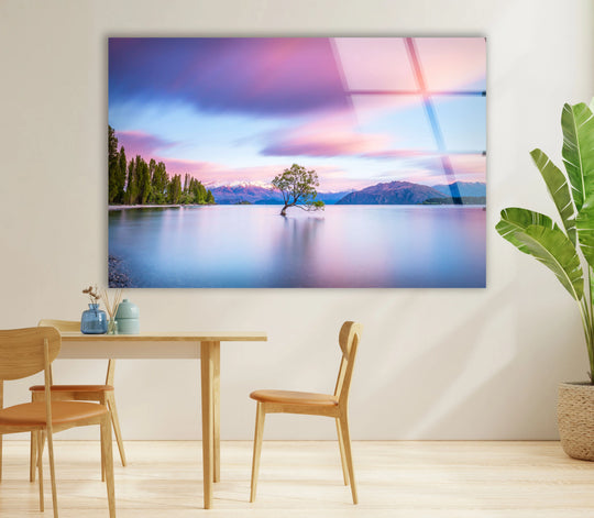 The stillness of the lake reflects in this landscape glass print, where quiet waters cradle a solitary tree under a tranquil sky, a serene wall prints.