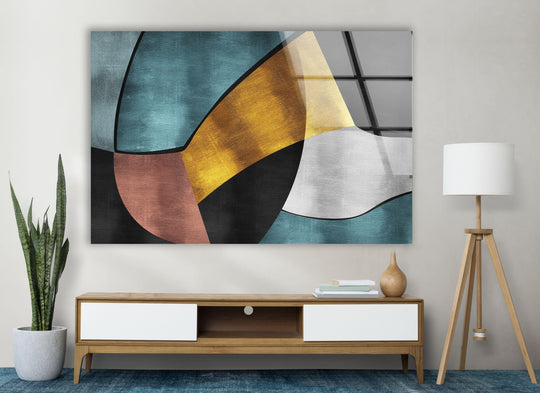 Geometric glass print decor featuring angular shapes in teal, gold, rust, and grey, as a piece of hanging wall art.