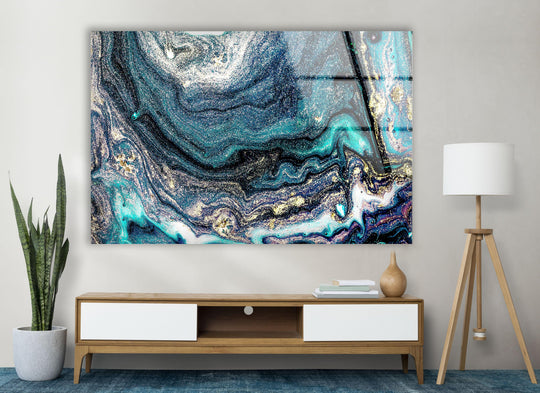 Vivid teal and gold abstract print wall art contrasts with deep navy and white in a swirling marble design.