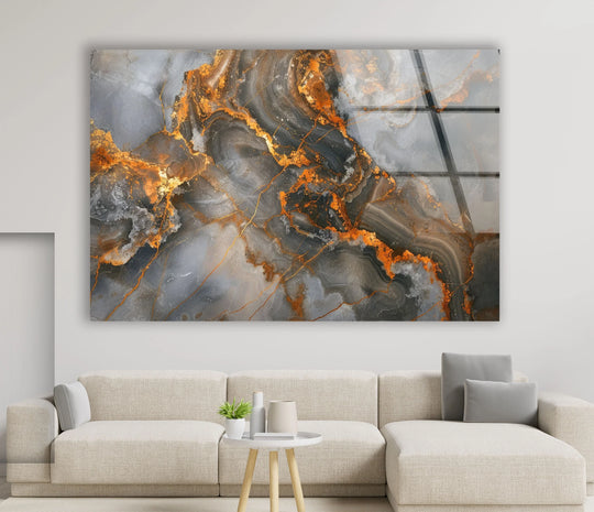 A luxurious abstract glass art piece evokes a mood of sophisticated drama with its swirling grey, black, and molten gold textures.