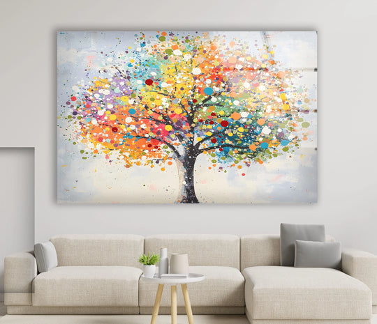 A vibrant glass wall art piece showcases a colorful tree with a dynamic transition between vivid hues of yellow, orange, and blue, embodying unique modern wall decor.