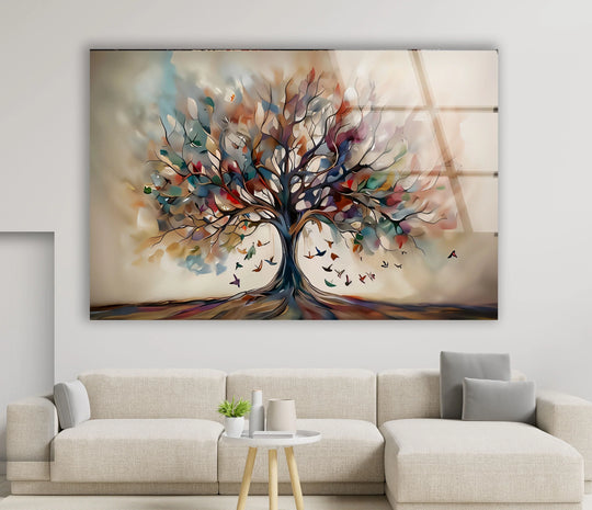 Abstract tempered glass wall art showcases a beige tree with layered colorful leaves and birds in flight.
