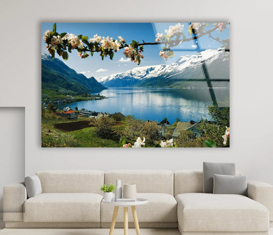 Minimalist design highlights the decorative wall art by emphasizing the vast negative space around the Norwegian fjord glass wall art, showcasing a tranquil lake and mountain scene.