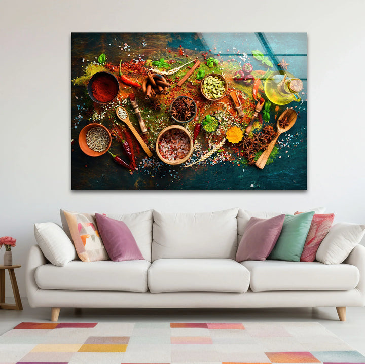 Colorful spices and herbs glass wall art displayed above a cream sofa adds rustic kitchen decor with vibrant reds, greens, and browns in a horizontal format.