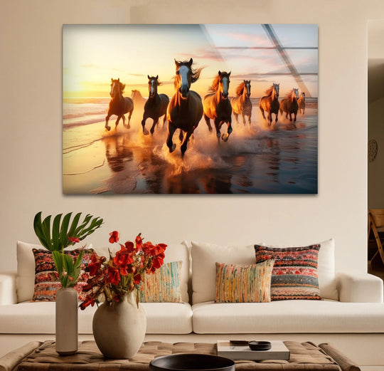 Panoramic glass printing of horses running on a beach during sunset, capturing their dynamic shapes and movement.