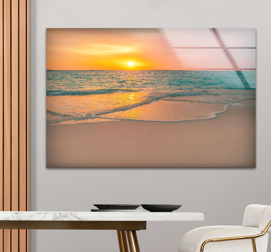 Serene mood conveyed in this tranquil sunset beach scene through wall art prints featuring soft orange glows over coastal ocean waves.