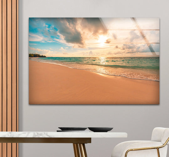 Highlighting the sunset's warm hues, the background enhances the golden hour beach wall art, a serene glass art painting featuring tranquil ocean waves and a beautiful beach scene.