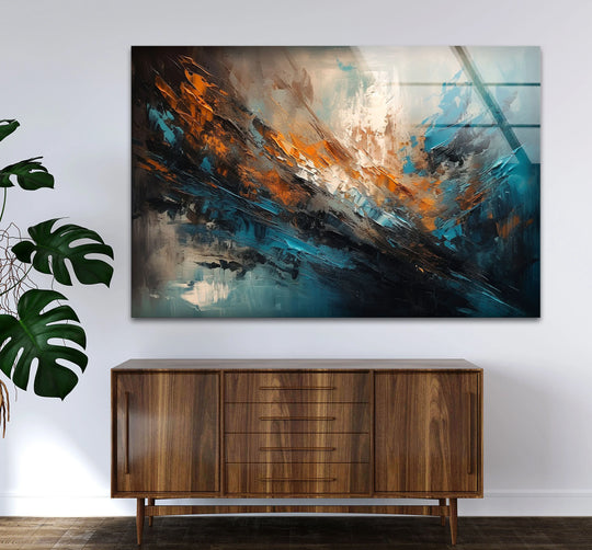 A dark walnut credenza with clean lines and brass accents complements the foreground of a vibrant teal and copper abstract glass wall art.