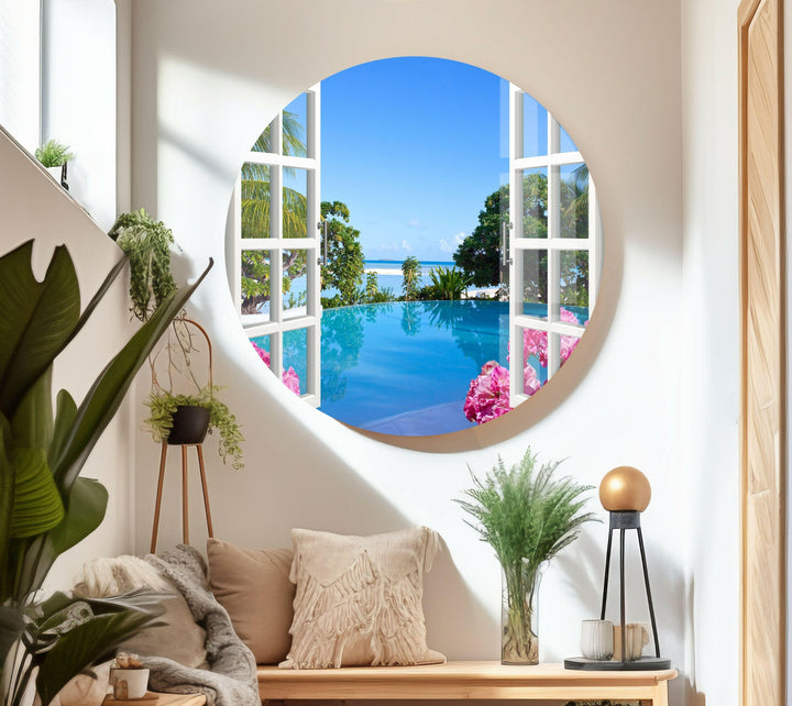 Elegant coastal-themed glass wall art displaying a bright blue ocean and tropical plants.
