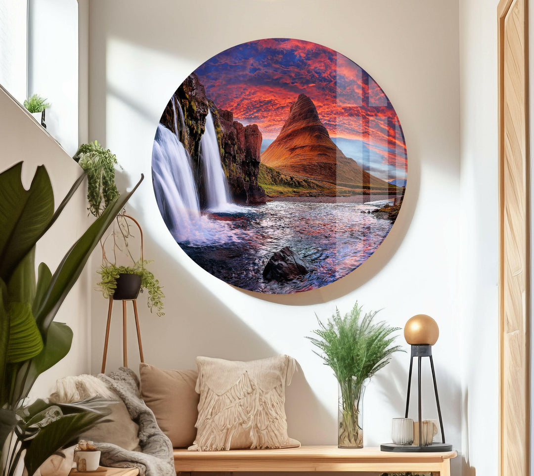 Panoramic landscape featuring a powerful waterfall flowing into a tranquil river.
