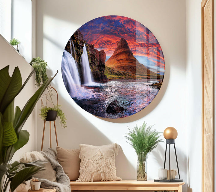 Panoramic landscape featuring a powerful waterfall flowing into a tranquil river.
