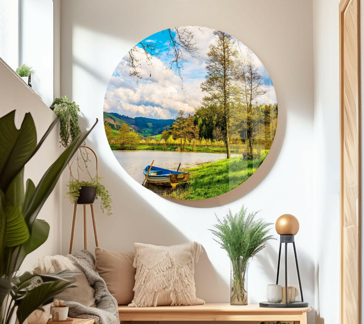 Scenic riverside wall art with a rustic boat docked along the grassy shore, bringing a touch of nature indoors.
