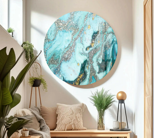 A stunning circular glass decorative wall art piece features shimmering silver and gold alcohol ink swirls in a luxurious, high-quality finish.