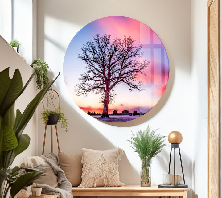 Modern glass wall art of a striking sunset scene with a solitary tree.
