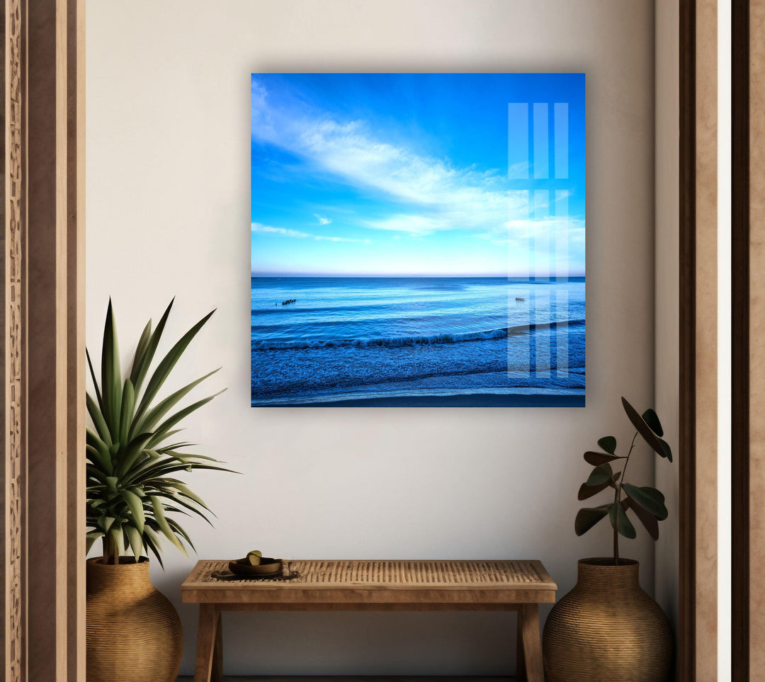 A panoramic ocean view featuring a brilliant blue sky and a peaceful shore.
