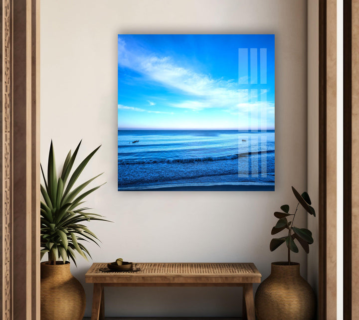 A panoramic ocean view featuring a brilliant blue sky and a peaceful shore.
