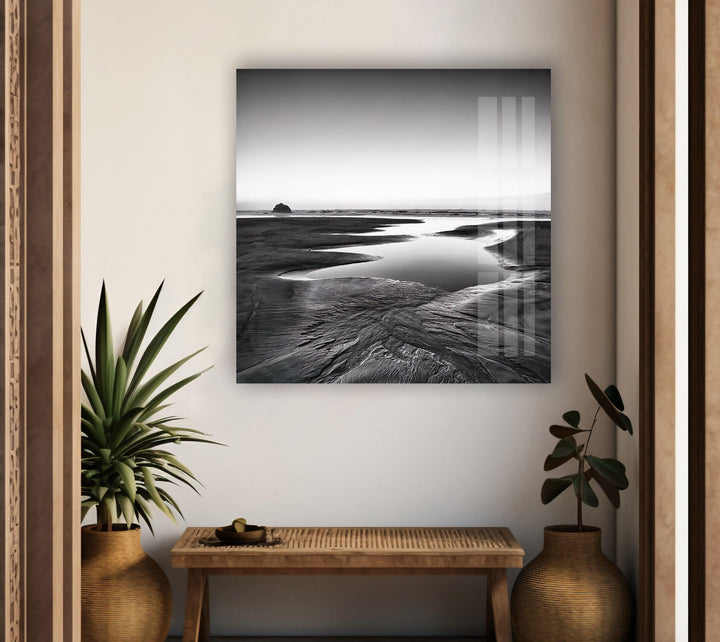 A mesmerizing black and white coastal view captured on glass, bringing a sense of tranquility to your living space.
