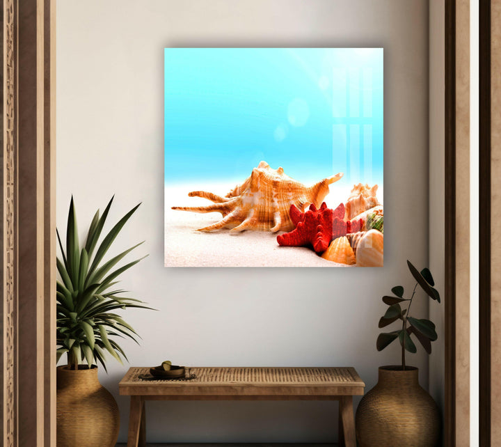 Coastal-themed glass wall art featuring seashells, starfish, and a serene beach setting.
