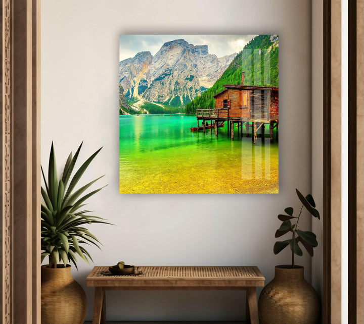 Nature paintings for sale depicting a peaceful mountain lodge over a scenic lake.
