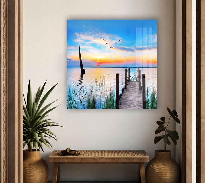 A mesmerizing landscape photo for sale featuring a sunset view over a calm lake with a wooden dock.
