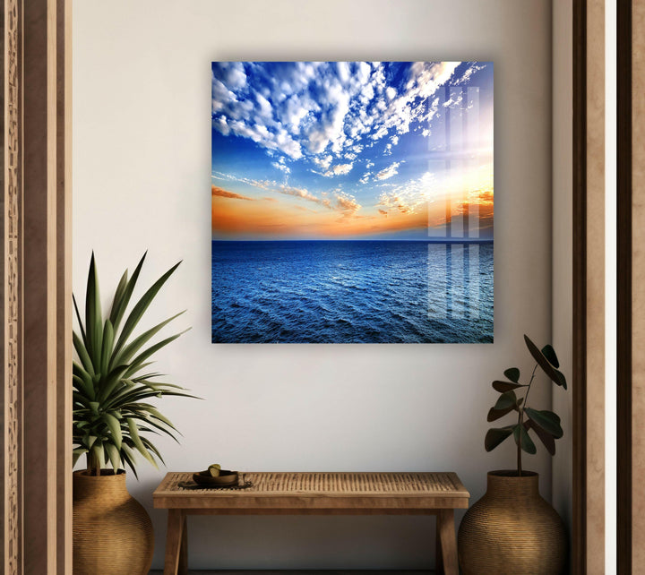 A panoramic ocean landscape, featuring deep blue waves and a warm sunset glow.

