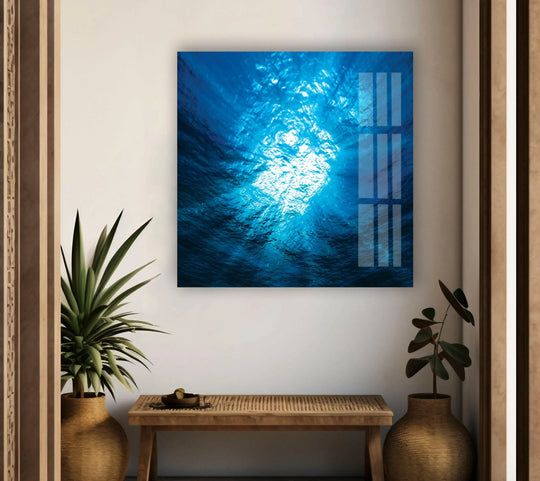 The blue ocean deep water glass wall art shows the depths of the sea and is stunning ocean decor and a landscape masterpiece on a white wall