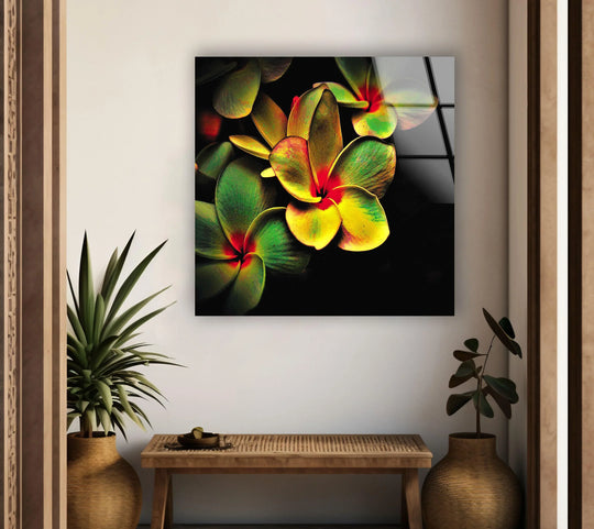 Vivid yellow flower glass art painting with intensely saturated petals in hues of green, yellow, and red against a dark background.