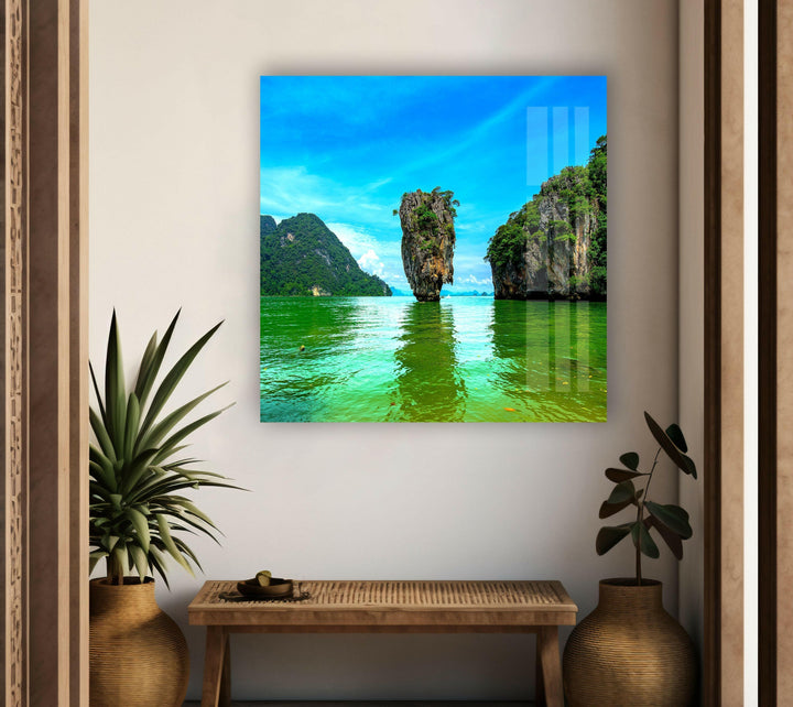 Nature paintings for sale displaying a tropical paradise with deep blue waters and towering cliffs.
